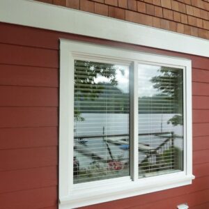 Gallery25 Slider Windows on a red house with white trim.