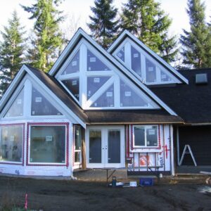 Gallery27 A new house being constructed with many windows.