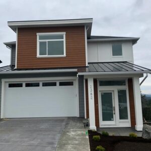 Gallery39 Modern house and entry doors with metal roof, and brown, white and grey siding.